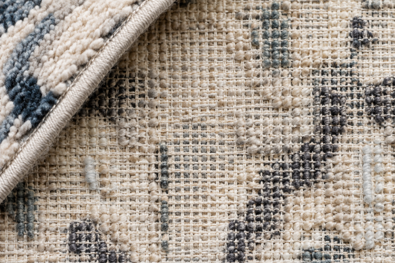 Tufted rug underside showing fabric/secondary backing